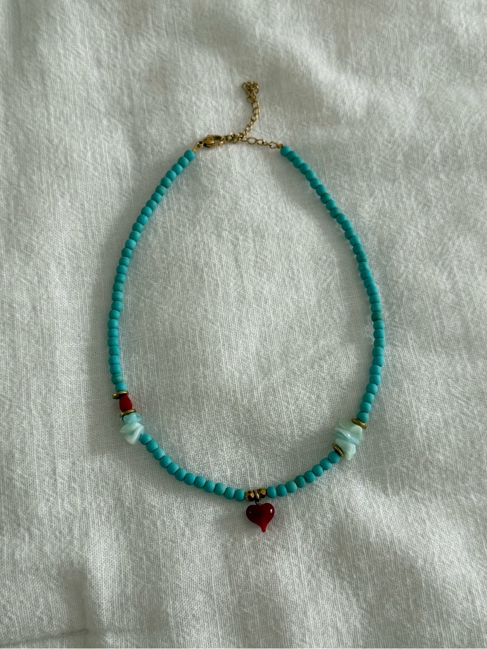 Turquoise choker necklace with red heart